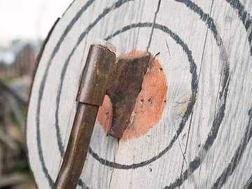 axe stuck in wooden target